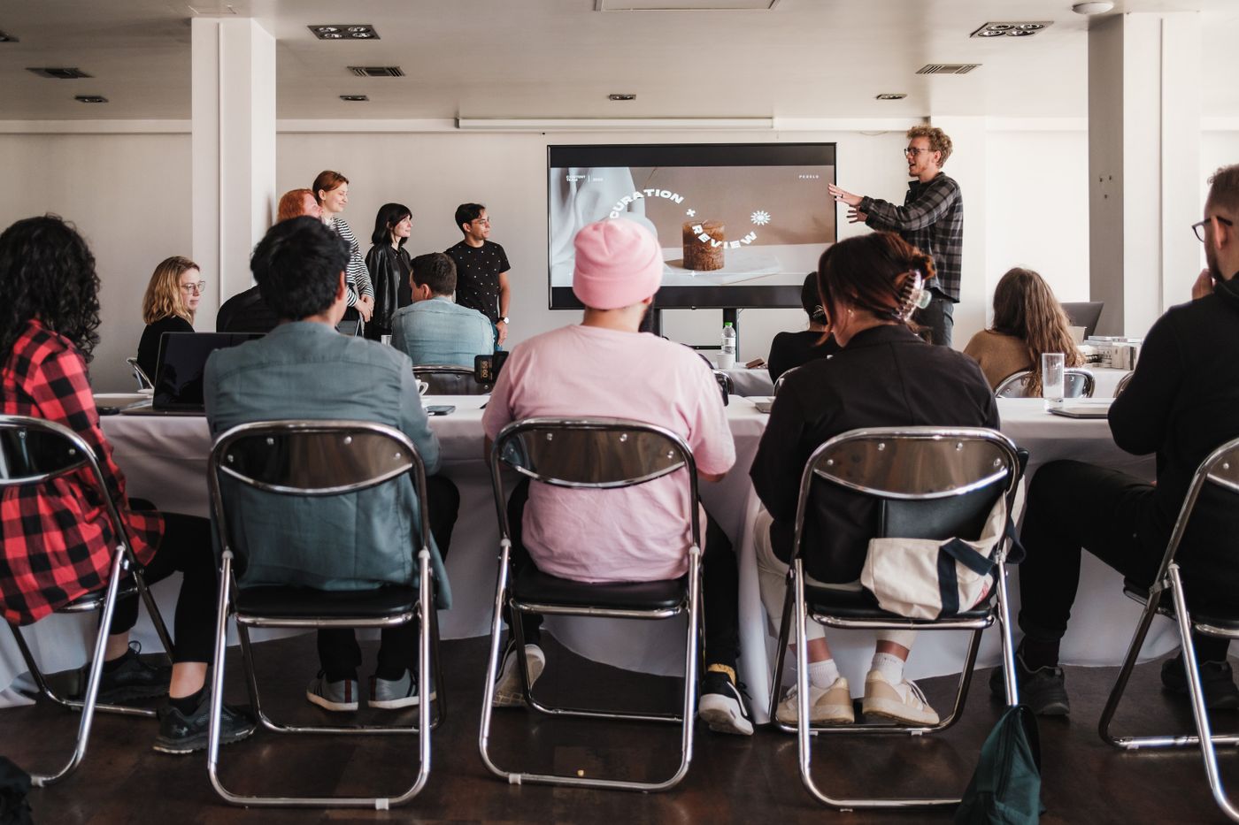 A presenter leading a workshop with a group of participants